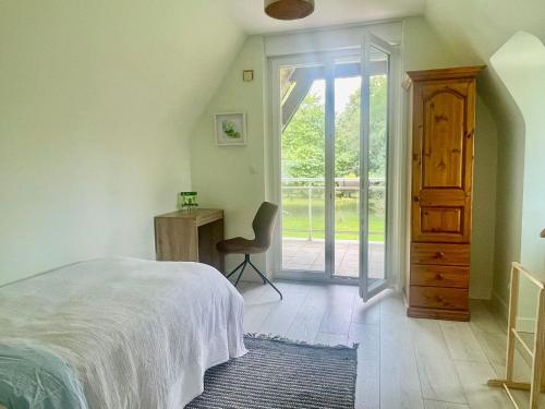 a bedroom with a bed and a desk and a chair at Foxgloves in La Motte