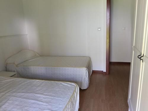 a small room with two beds and a chair at La Casuca de Remin in Arredondo