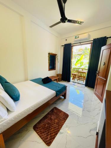 a bedroom with a bed and a large window at Beach heaven villa in Matara