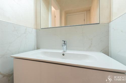 a bathroom with a sink and a mirror at Residence Sanremo in Sanremo