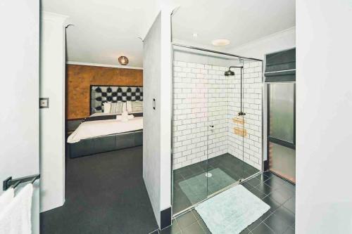 a bedroom with a bed and a glass shower at Quite and nature paradise in Byford