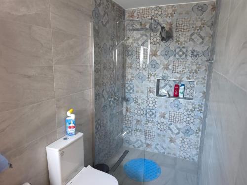 a bathroom with a shower with a toilet and a shower at Carolyn Villa is a Luxury 4-Bedroom Villa with Private Pool in Ayia Napa in Ayia Napa