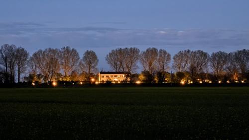 a house in the middle of a field at night at Ca'Visentin in Loreo