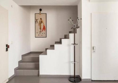 a staircase in a white room with a picture on the wall at Oַ&O Group-Amazing APT Bat-Yam 3 Min Walk To Beach in Bat Yam