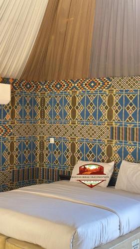 a bedroom with a bed with blue and white tiles at Wadi Rum Nebula, Calm Atmosphere in Wadi Rum