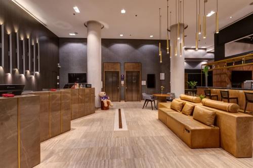 a lobby with a brown couch and a bar at Double Tree by Hilton São Paulo Itaim in Sao Paulo