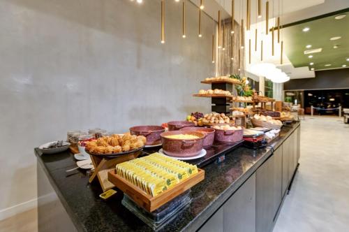 a buffet line with many different types of food at Double Tree by Hilton São Paulo Itaim in Sao Paulo