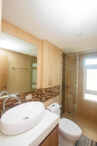 a bathroom with a sink and a toilet and a shower at Calypso Condo Naiharn in Phuket