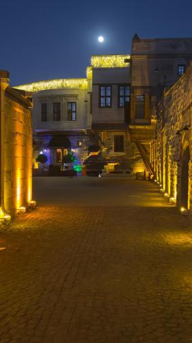 an empty street at night with a building with lights at Four Mansions Hotel in Kayseri