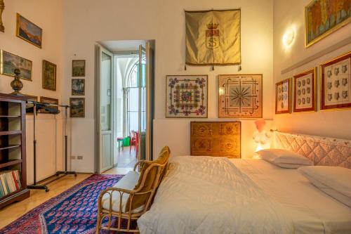 a bedroom with a large bed and a chair at Charme e storia apartment in Brescia center in Brescia