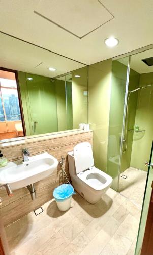 a bathroom with a toilet and a sink and a shower at Vortex Residenc klcc serviced apartment near by Bukit Bintang in Kuala Lumpur