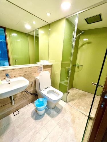 a bathroom with a toilet and a sink and a shower at Vortex Residenc klcc serviced apartment near by Bukit Bintang in Kuala Lumpur