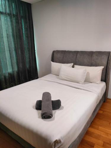 a bed with a towel laying on top of it at Vortex Residenc klcc serviced apartment near by Bukit Bintang in Kuala Lumpur