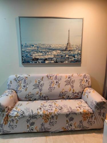a couch in a room with a picture of the eiffel tower at Vortex Residenc klcc serviced apartment near by Bukit Bintang in Kuala Lumpur
