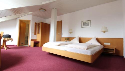 a bedroom with a large bed in a room at Hotel am Neckar in Nürtingen