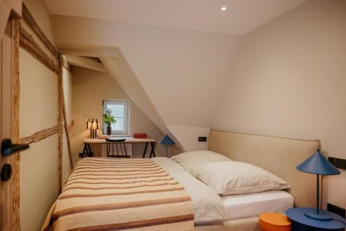 a bedroom with a bed and a table and a window at Design Hideaway On The Lauenburg Lake District in Schmilau