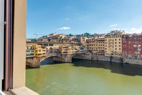 a view of a bridge over a river with buildings at Marmo - Sweet Dreams in Florence in Florence