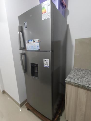 a stainless steel refrigerator in a kitchen next to a counter at Exclusive, Elegant Atlantis Comfortable in Santa Cruz de la Sierra