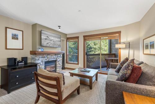 a living room with a couch and a fireplace at Horstman House by Whistler Premier in Whistler