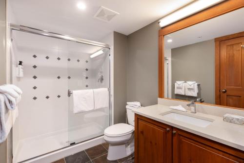 a bathroom with a shower and a toilet and a sink at Horstman House by Whistler Premier in Whistler