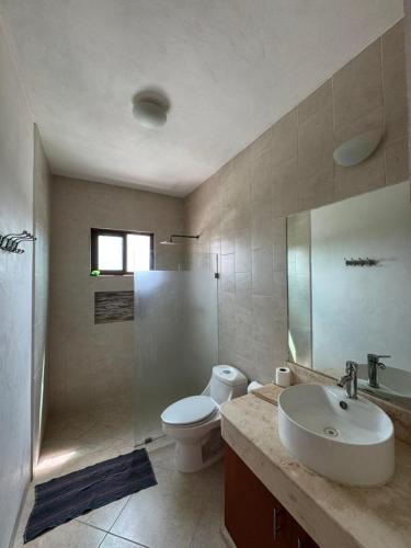 a bathroom with a sink and a toilet and a shower at Punta Arena Condominium in Chicxulub