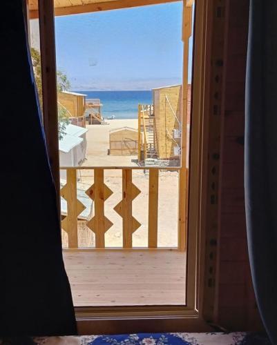 a view of the beach from an open window at The Uniqueness Camp in Nuweiba‘ el Muzeinah
