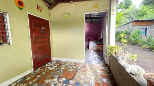 an entrance to a house with a door and a tile floor at Casa AnaMar in Moyogalpa