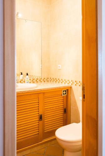 a bathroom with a sink and a toilet and a mirror at Sunny Ocean view, Praia del Rey A7 in Óbidos
