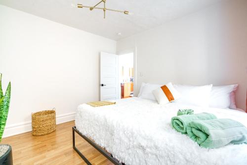 a bedroom with a white bed with towels on it at Prime Location Top Rated Clean Parking Free! in Columbus