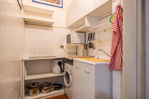 a small kitchen with a washing machine in it at Charme e storia apartment in Brescia center in Brescia