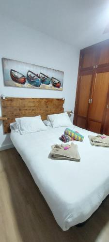 a large white bed with glasses on top of it at Villa Miriam in Tinajo