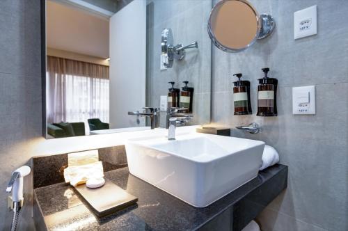 a bathroom with a sink and a mirror at Double Tree by Hilton São Paulo Itaim in Sao Paulo