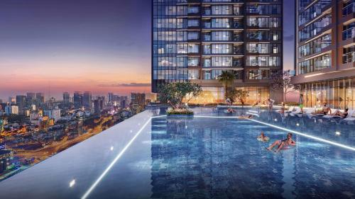 a swimming pool in a building with people in it at Lancaster Legacy Hotel & Apartments in Ho Chi Minh City