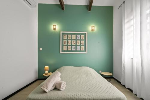 a bedroom with a bed with two towels on it at La KazOranj in Saint-Pierre