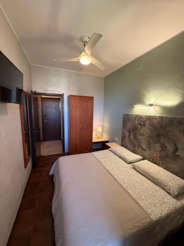 a bedroom with a bed and a ceiling fan at Casetta Cortese in Opera
