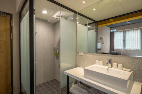 a bathroom with a sink and a shower at Cho Hotel in Taipei