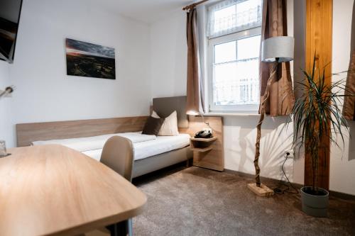 a living room with a couch and a window at Hotel Gasthof Koch in Daaden