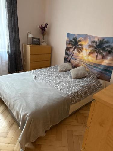 a bedroom with a bed with palm trees on it at Mieszkanie w Centrum in Białystok
