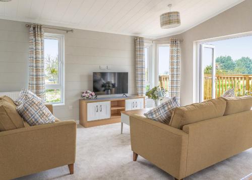 TV a/nebo společenská místnost v ubytování Hawthorn Glen Lodges