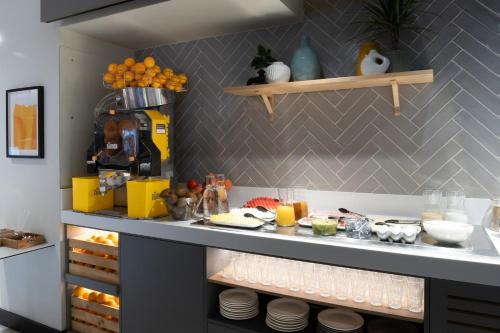 a kitchen with a counter with food on it at voco Bilbao - City by IHG in Bilbao