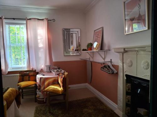 a room with a table and chairs and a window at Jesmond B&B Kingsize Ensuite Room 2 in Hull