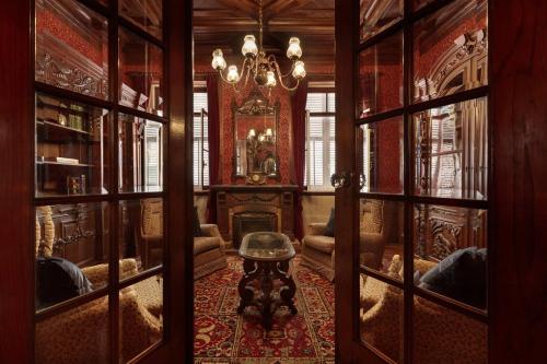 a living room with a chandelier and a room with glass doors at Foz Townhouse- Sea, Garden & Garage in Porto