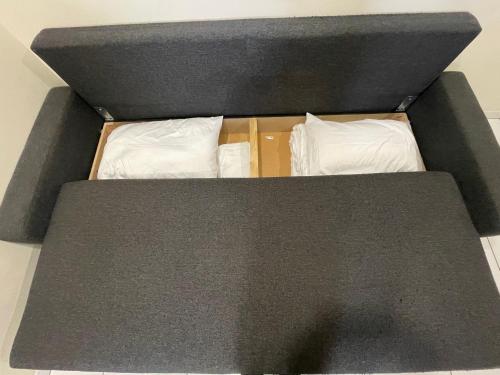 a bed with two white pillows in a box at Résidence Chene- 15 MN de Paris et 05 MN d'Orly Aéroport in Viry-Châtillon