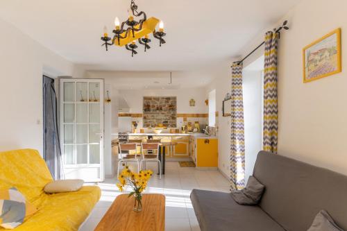 a living room with a couch and a table at Chez l'Oncle in Larnas