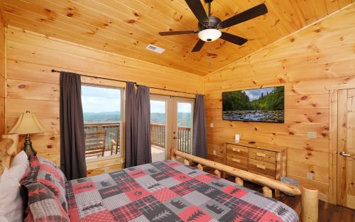 a bedroom with a bed and a ceiling fan at Eagles View 2.0 - Gorgeous Mountain Views, Hot Tub, Pool Table, + Games! in Gatlinburg