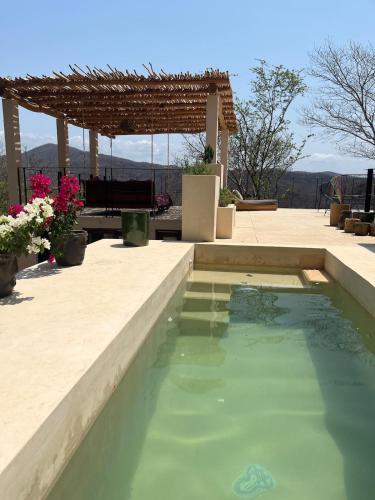 a swimming pool in a backyard with a pergola at Villa Xololo Luxury Villa, La Boquilla Beach in Arroyo Cruz
