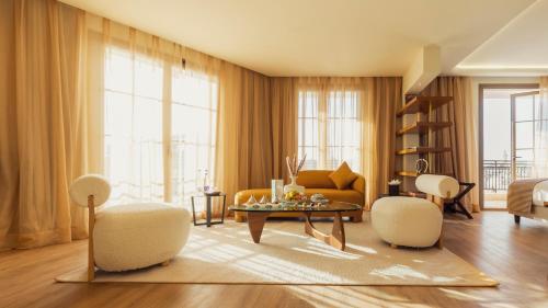 a living room with a couch and a table at Le Square By Onomo Collection in Casablanca