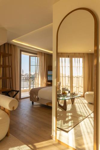 a bedroom with a bed and a large mirror at Le Square By Onomo Collection in Casablanca