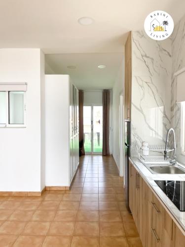 a kitchen with a sink and a counter top at Atico del Sol by Babiniliving in Puerto del Rosario