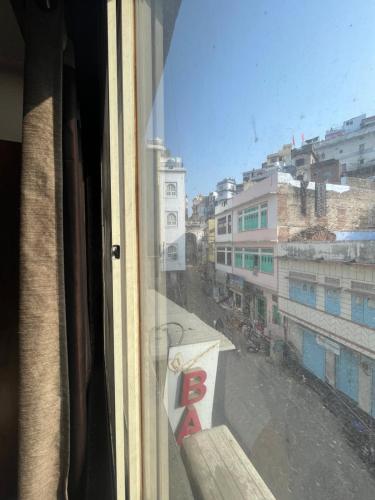 a view of a city street from a window at Hotel Bansuri I opposite shreenathji temple 80mtr away 966o9o1oo6 in Nāthdwāra